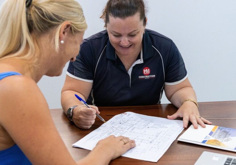 H&M Tracey Construction team member reviewing floor plans with a property investor to plan a Broome investment build timeline at the H&M Tracey office in Broome, Western Australia.
